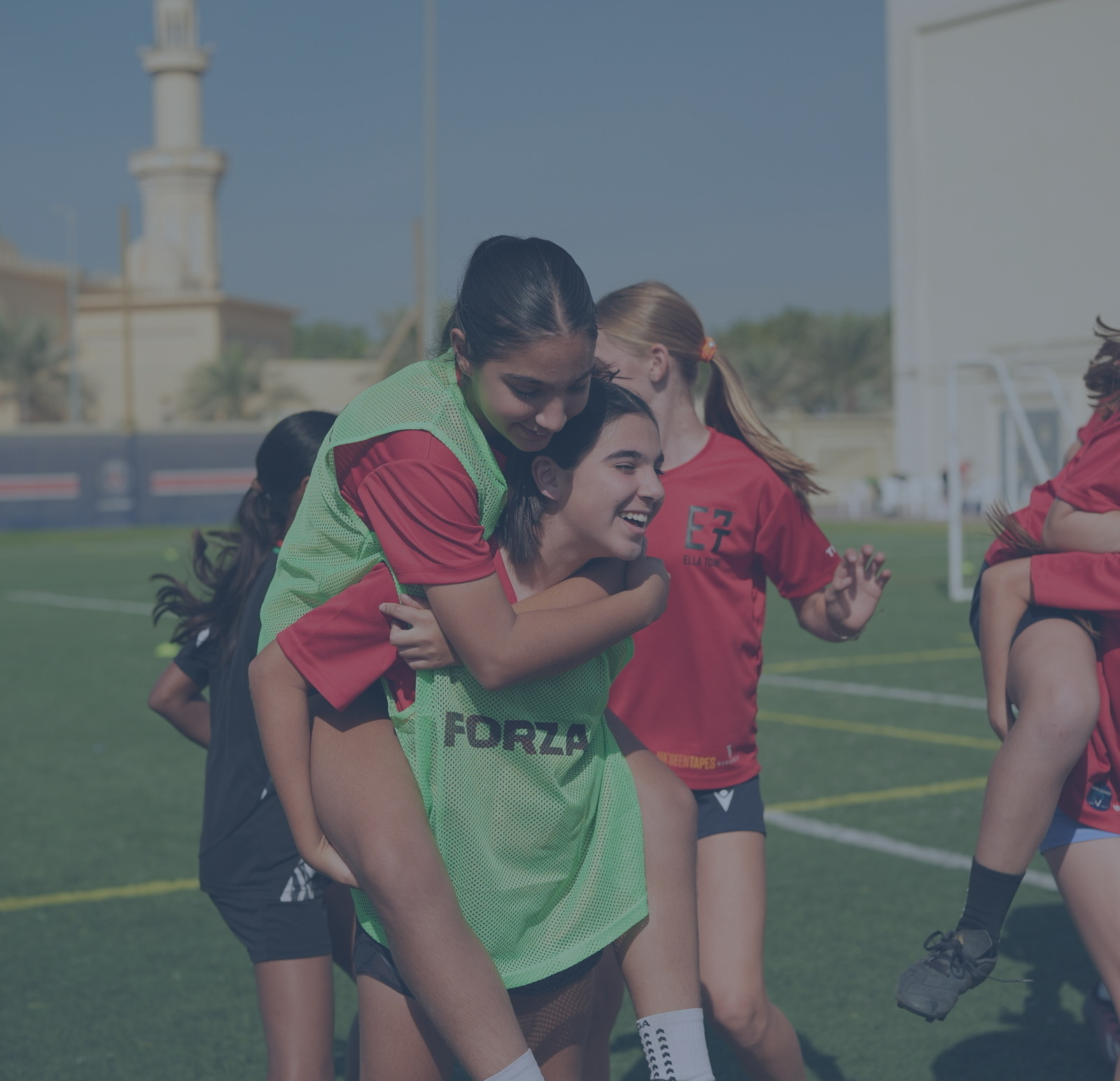 Girls celebrating together during football training