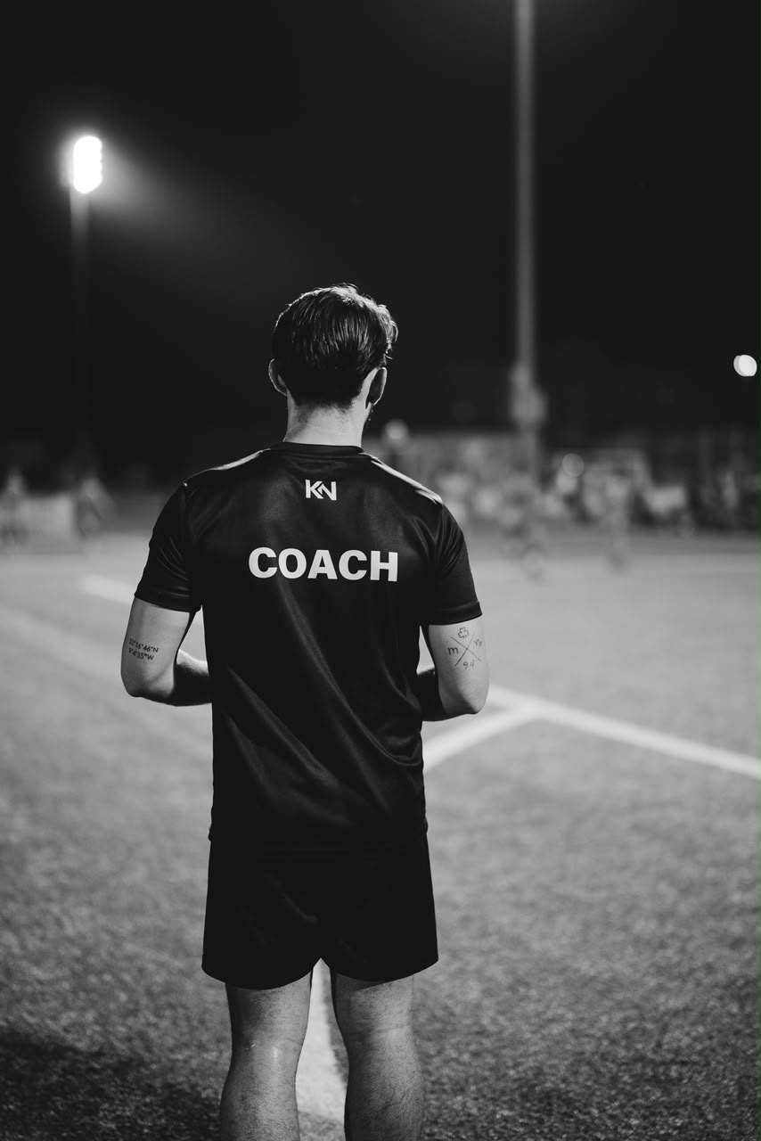 Jason coaching under floodlights