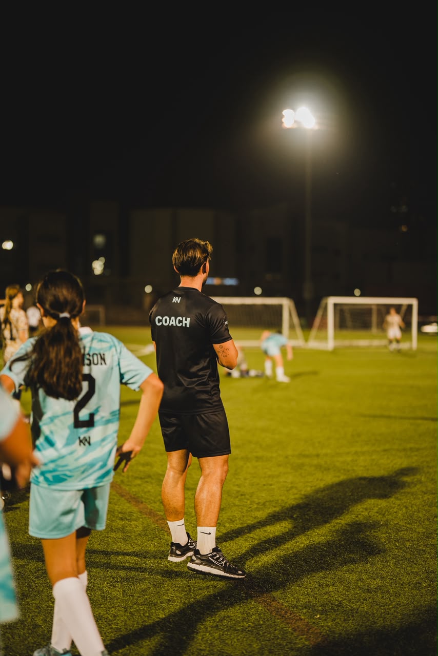 Jason watching play on a football pitch