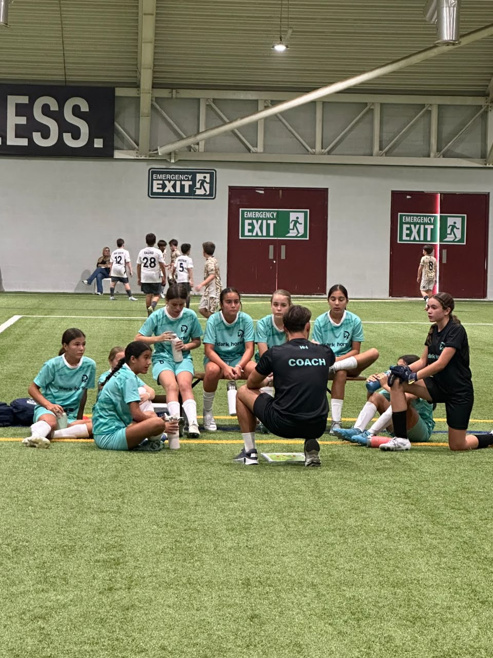 Jason speaking with a youth team during a team talk